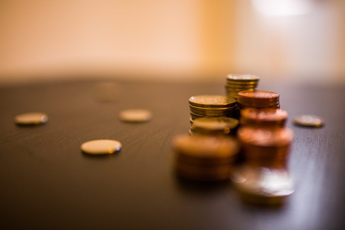 A small collection of copper coins in a neat stack upon a table