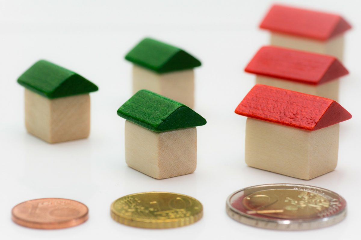 six monopoly houses, with three coins in front