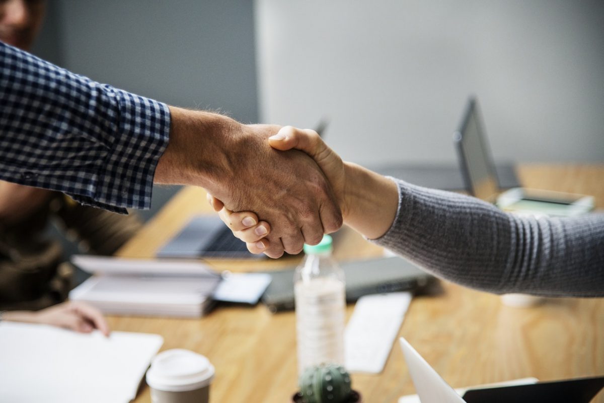 Close-up of a handshake between formally dressed individuals
